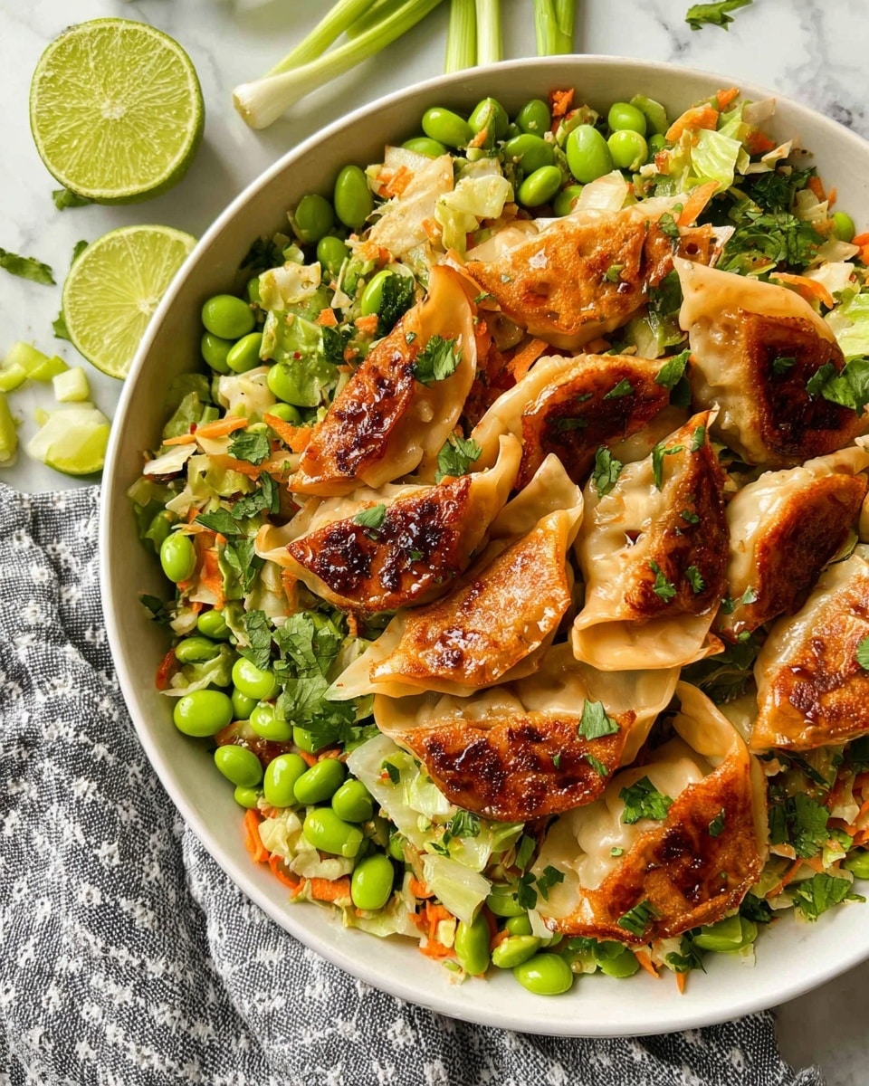 A white round bowl is filled with layered food starting at the bottom with bright green edamame and fresh herbs like cilantro, mixed with small chopped orange carrot pieces and creamy white cabbage bits scattered throughout. On top, there are several golden-brown, pan-fried dumplings with slightly crispy edges and a shiny glaze, unevenly placed among the vegetables. Lime slices are placed on one side of the bowl, adding a pop of light green color. The bowl sits on a white marbled surface with a gray checkered cloth in the background, and a sliced lime half and green onion lay nearby. photo taken with an iphone --ar 4:5 --v 7
