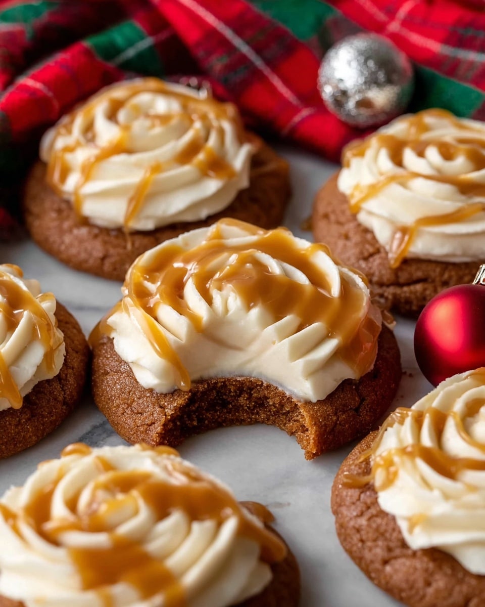 The image shows several round cookies with a brown, slightly rough texture, each topped with a generous swirl of smooth white cream piped in a circular rose-like pattern. Drizzled over the cream is a glossy, light caramel sauce that drips slightly down the sides. One cookie at the center has a bite taken out, revealing a soft, dense interior with the same white cream layer beneath the bite. The cookies rest closely together on a surface with a white marbled texture, and a small red Christmas ornament and a piece of red and green plaid cloth are visible in the background, adding a festive touch. photo taken with an iphone --ar 4:5 --v 7