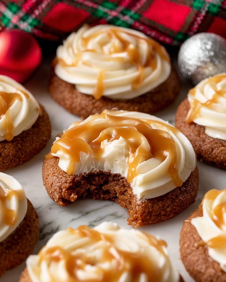 This image shows several round brown cookies arranged close together on a white marbled surface, each topped with a thick layer of white cream frosting piped in a rose shape. Over the frosting, there is a generous drizzle of golden caramel sauce that adds a shiny texture. One cookie in the center has a bite taken out, revealing a soft inner texture with the cream layer beneath. In the background, a colorful red and green cloth and two small holiday ornaments, one red and one silver, add a festive touch. photo taken with an iphone --ar 4:5 --v 7