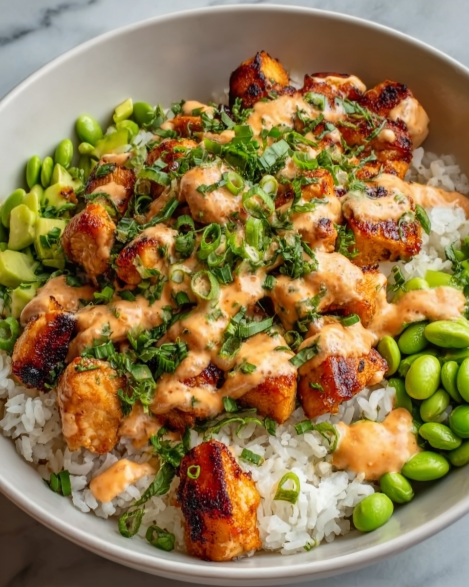 A white bowl filled with white rice as the bottom layer, topped with grilled golden-brown chicken pieces covered in a creamy orange sauce. Fresh green cucumber slices are placed on one side of the bowl, and the dish is garnished with small bits of green herbs sprinkled evenly on top. The textures show the soft rice, tender chicken with slight char marks, smooth sauce, and crisp fresh cucumber. Photo taken with an iphone --ar 4:5 --v 7