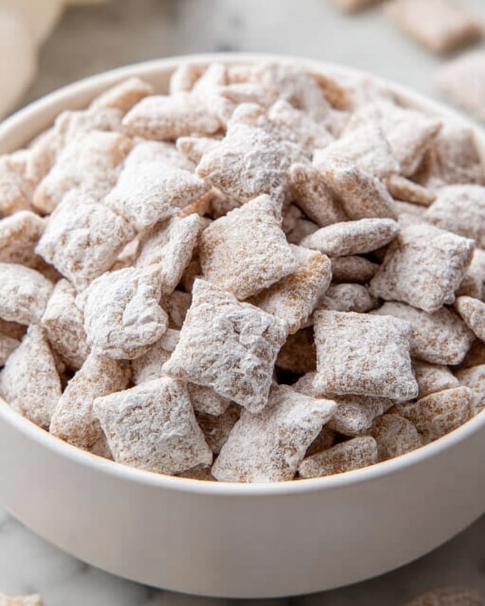 A close-up image of a white bowl filled with many small square cereal pieces that are covered in a white powdery coating, giving them a frosted look. The cereal pieces are slightly textured with some rough edges, and the bowl sits on a white marbled surface. The overall color is soft beige with the white powder making the cereal appear light and airy. photo taken with an iphone --ar 4:5 --v 7