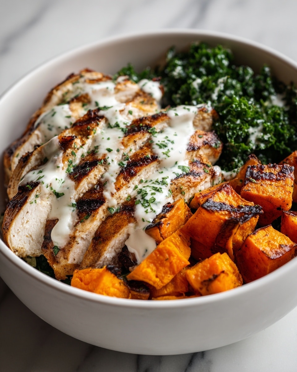 A white bowl filled with three main layers: on the bottom right, orange roasted sweet potato cubes with a slightly charred texture; above them, a pile of bright green chopped kale with a fresh leafy texture; and on the left side, grilled chicken breast slices topped with a drizzle of creamy white sauce and sprinkled with green herbs and small black pepper flakes. The ingredients are neatly arranged side by side, showing vibrant colors and textures, all set on a white marbled surface. photo taken with an iphone --ar 4:5 --v 7